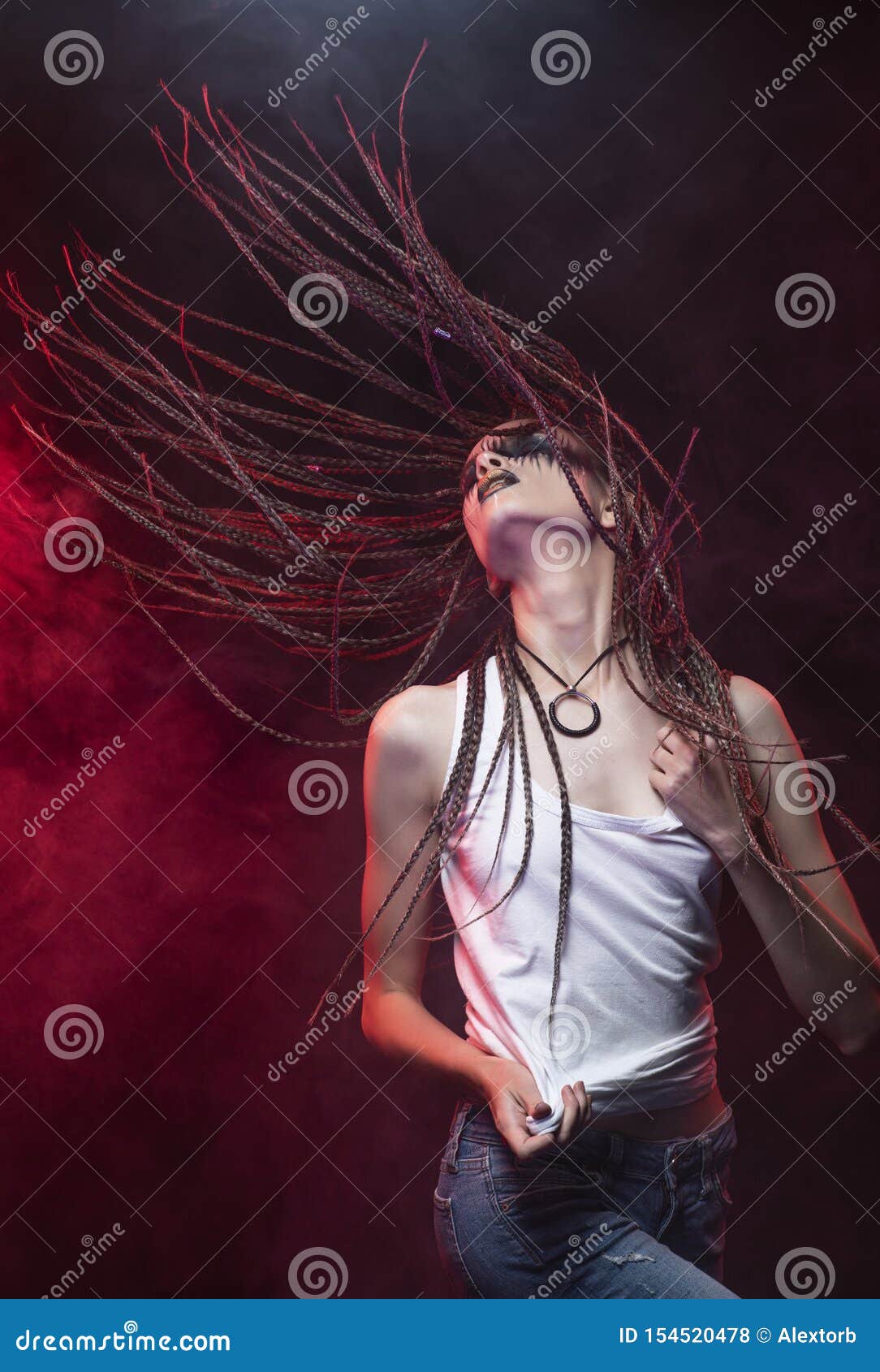 Emotionales Foto eines schönen dünnen Mädchens mit kreativem Make-up und einer Frisur von cornrows, tragendes weißes T-Shirt, tanzende Wellen ihre Borten im roten Rauche Begrifflich, Handels, Entwurf annoncierend