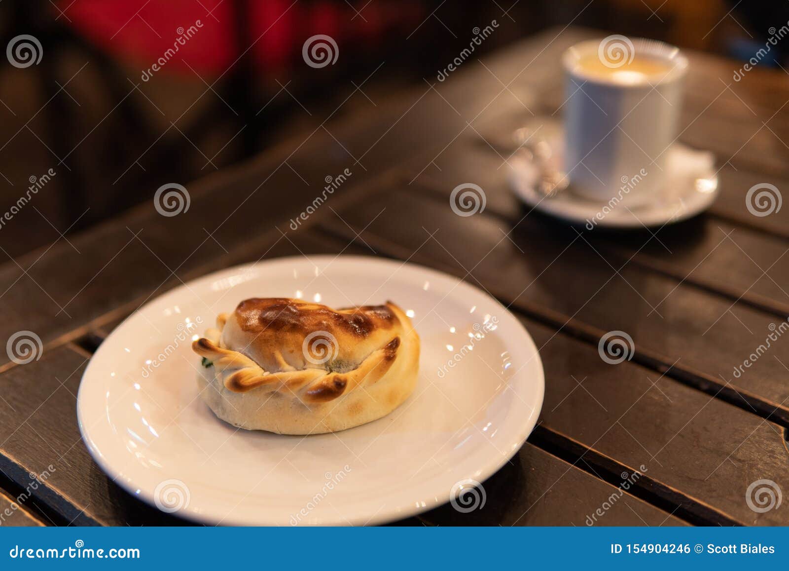empanada on plate with coffee