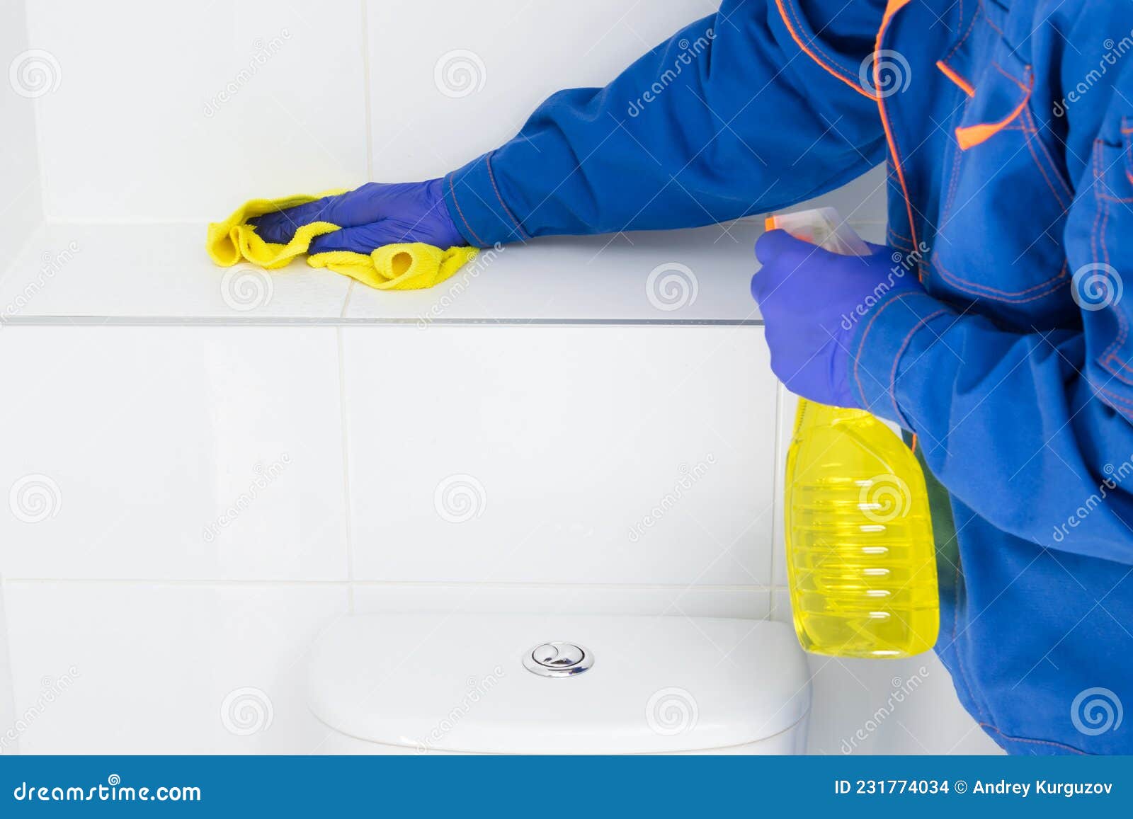 an employee of the cleaning company wipes the tiles in the bathroom using special products