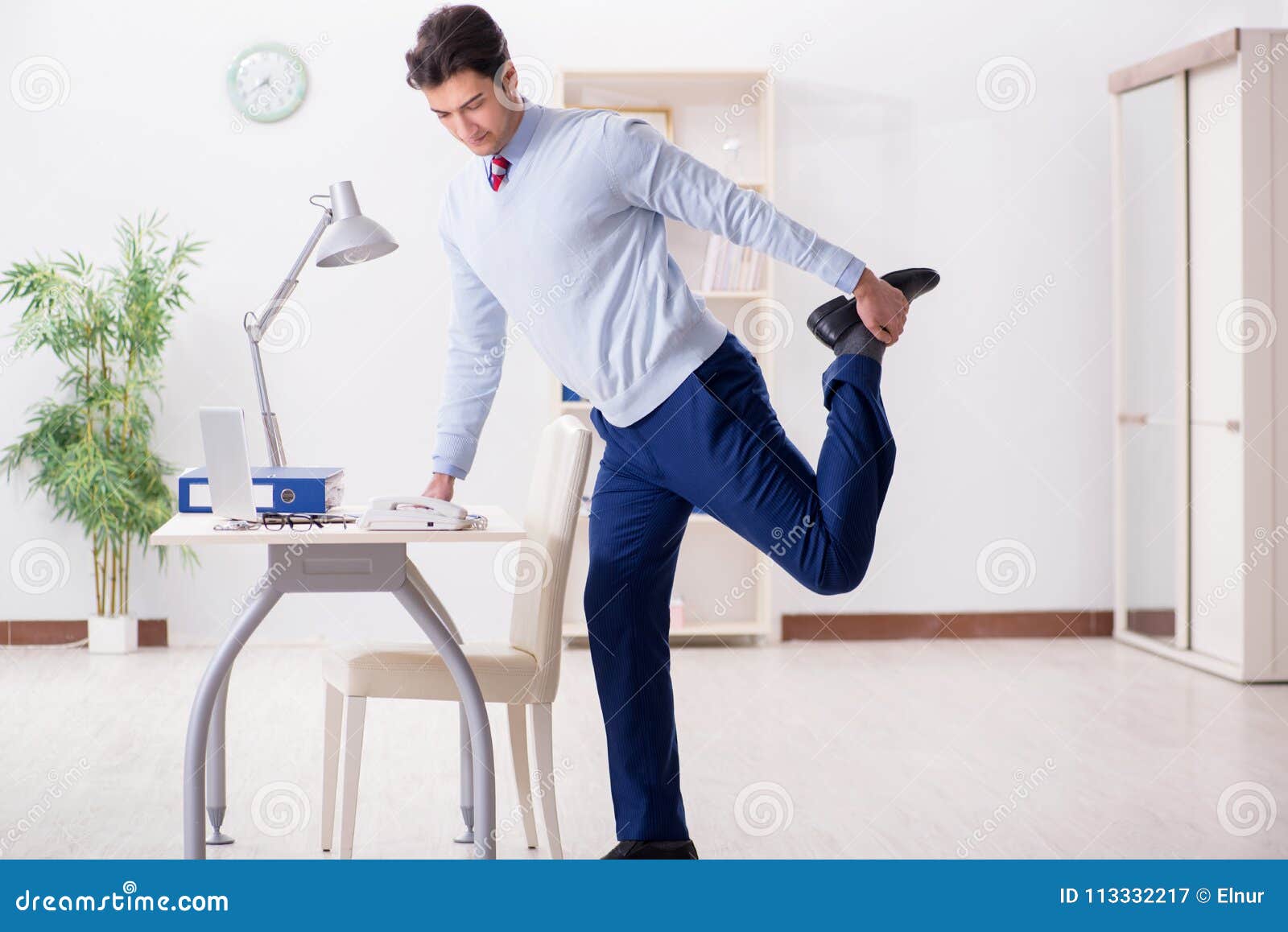 The Employee Doing Stretching Exercises in the Office Stock Image