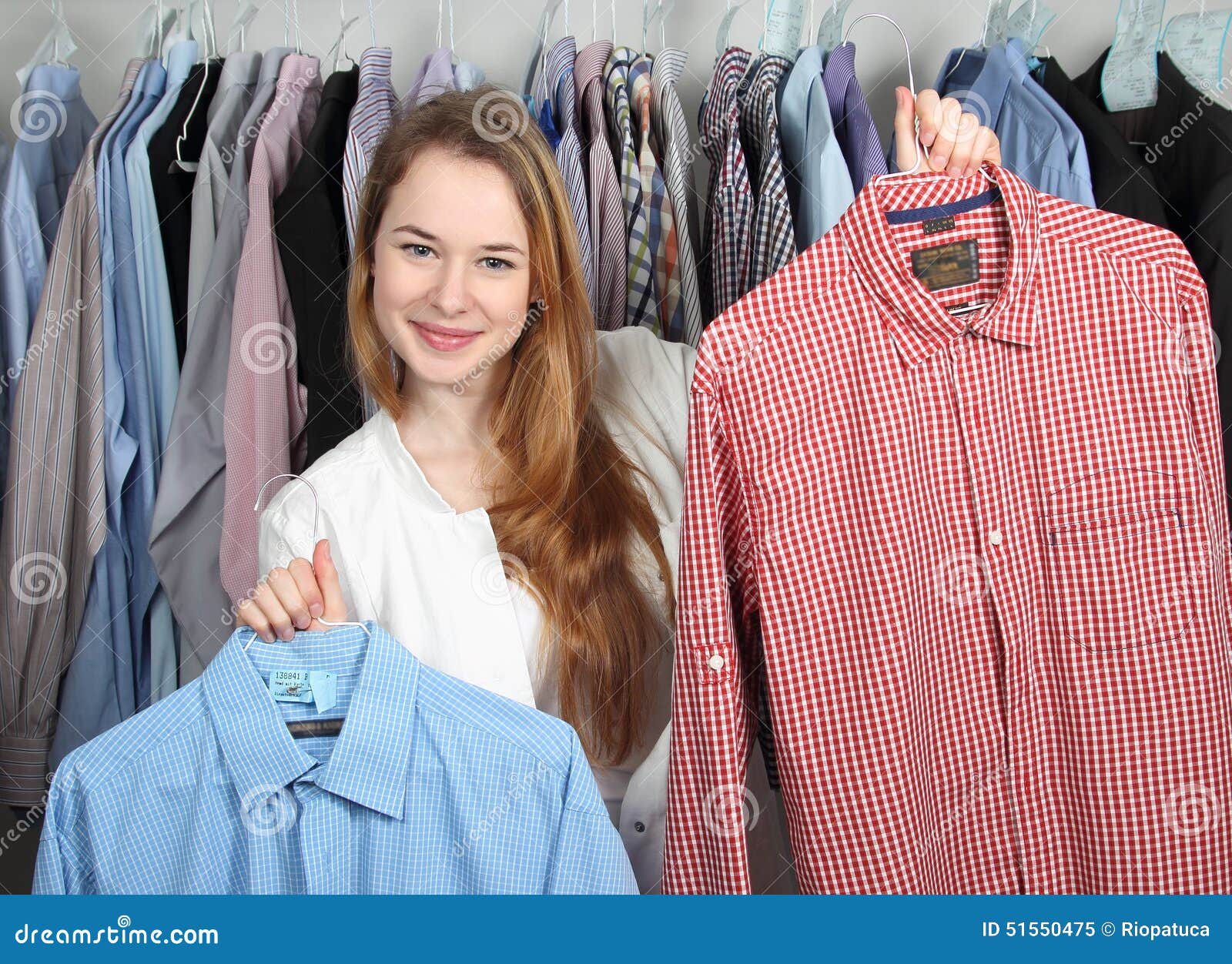 Employee of a Dry Cleaning Presenting Two Clean Shirts Stock Image