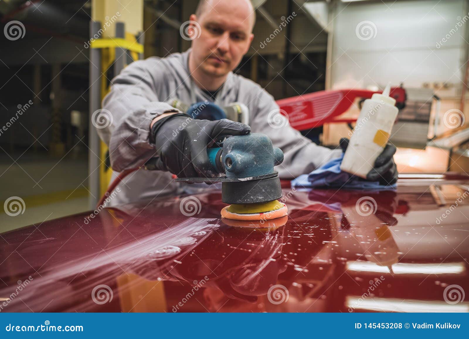 Employee In The Shop Painting The Car Body Polishes