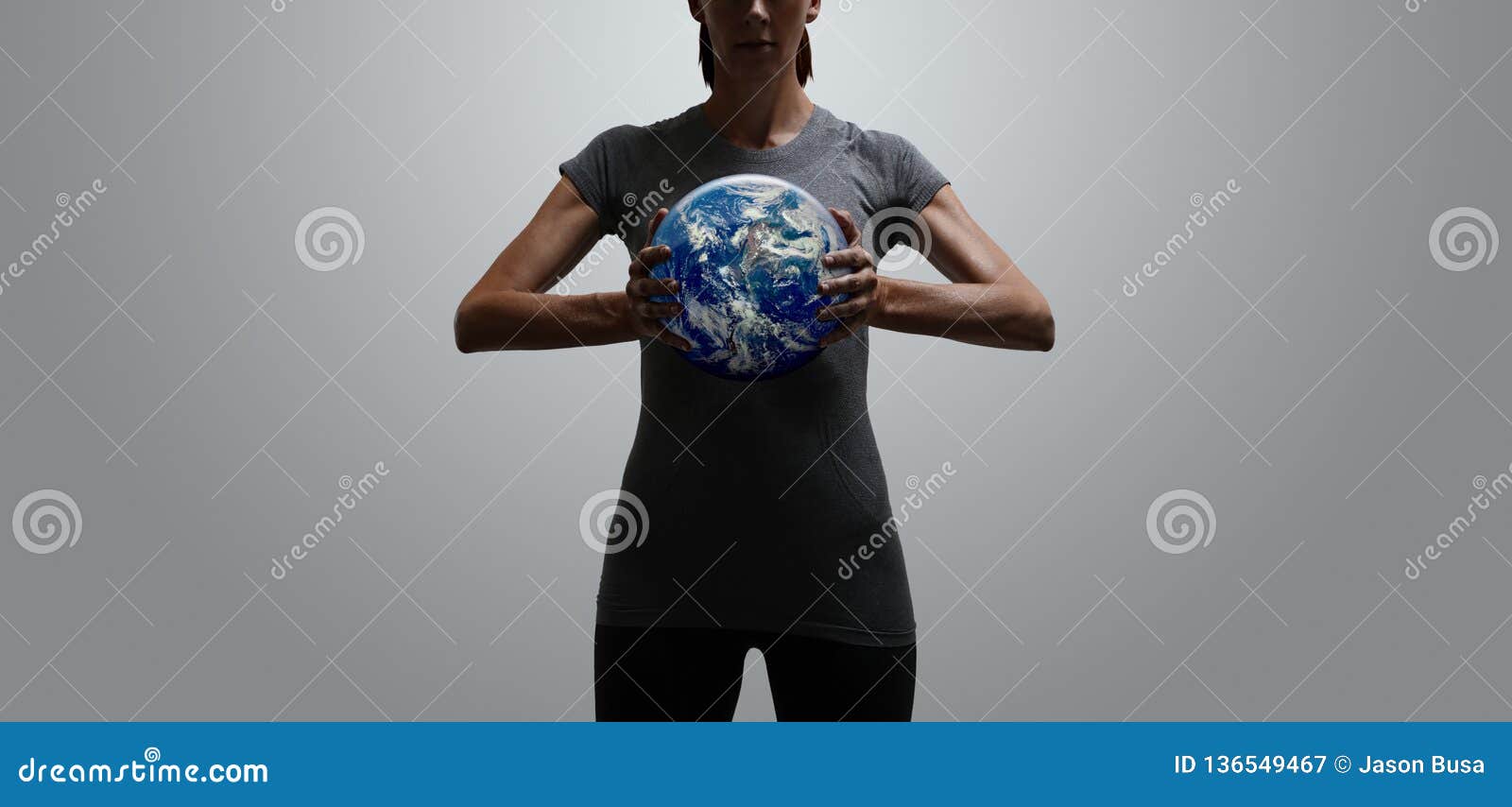 empowered fit woman holding world in her hands