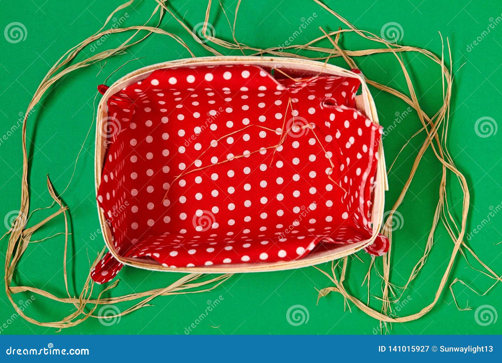 Empty Basket with Red Textile on Green Background. Stock Image Image