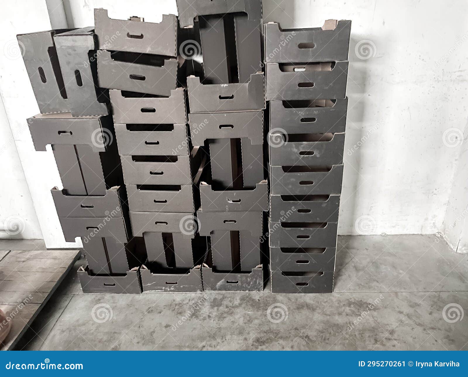 Empty Black Cardboard Boxes for Apples and Fruits in a Warehouse. Stock