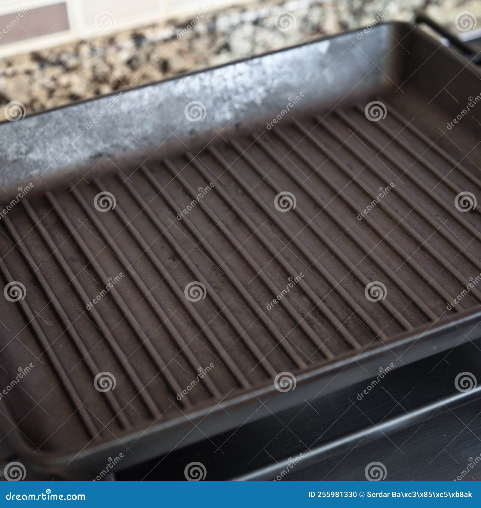 Empty Black Cast Iron Grill Pan on Gas Stove in a Modern Kitchen Stock