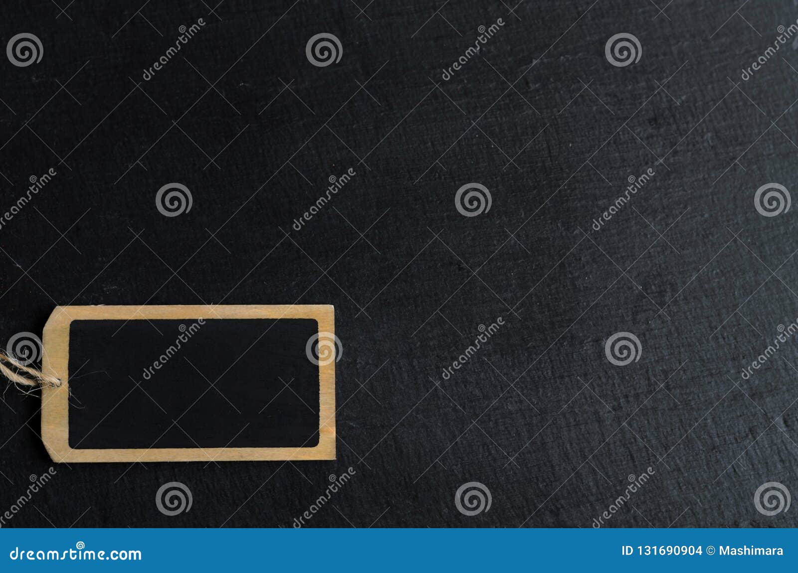 Empty Blackboard Label for a Short Message on Black Background, Copyspace for Your Text Stock