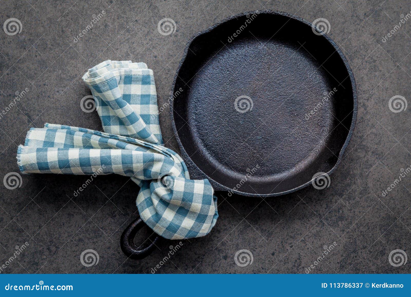 empty cast iron skillet frying pan flat lay on dark stone background with copy space .