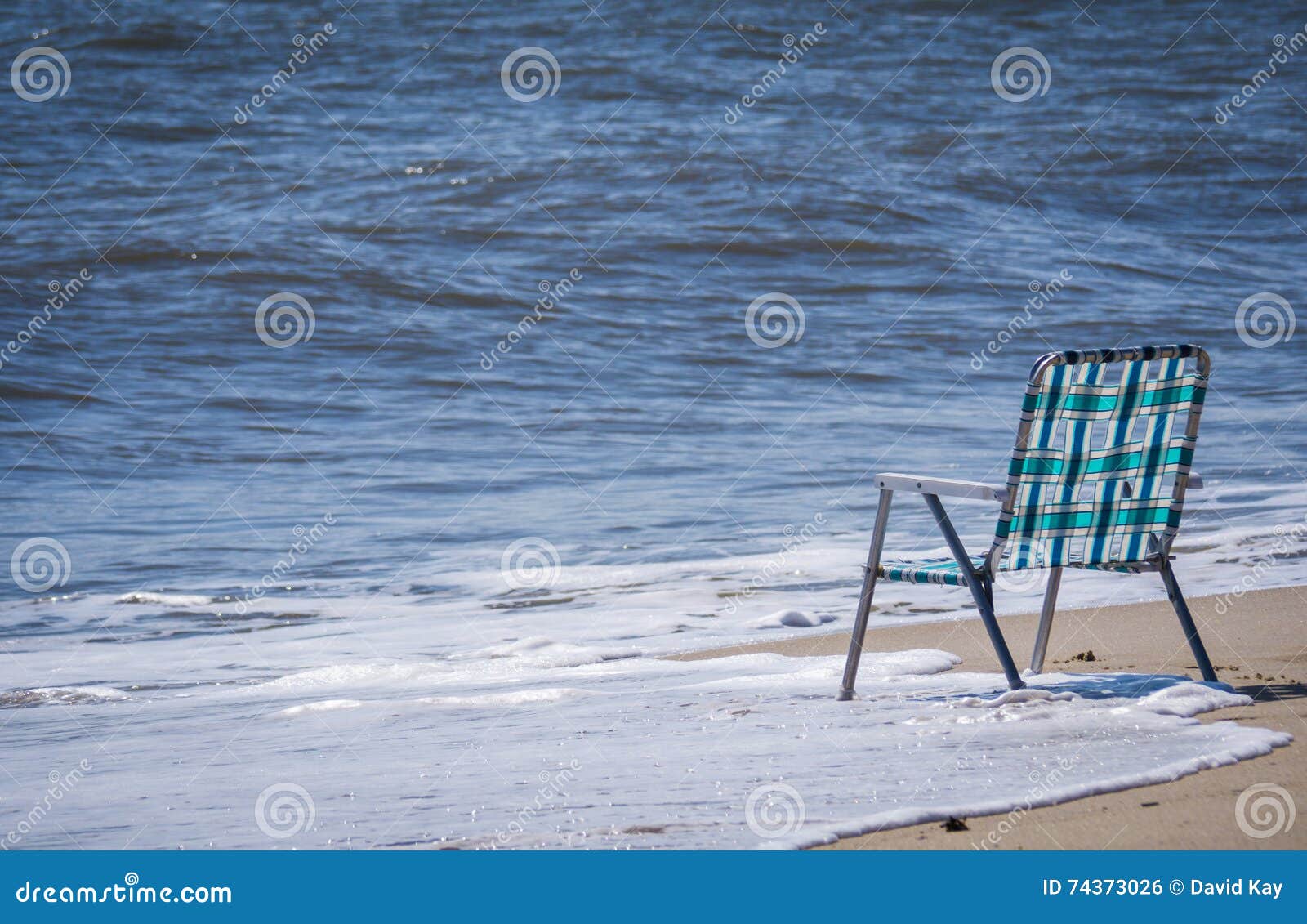 Empty chair at the beach stock photo. Image of waves 74373026
