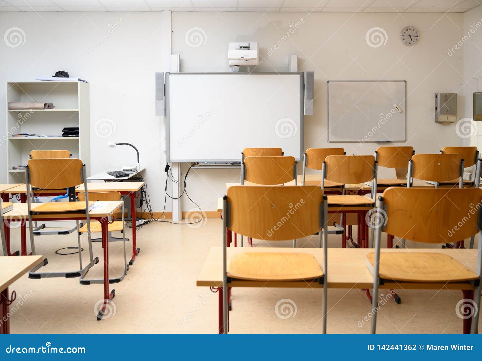 Empty Classroom With An Interactive Whiteboard Desks And