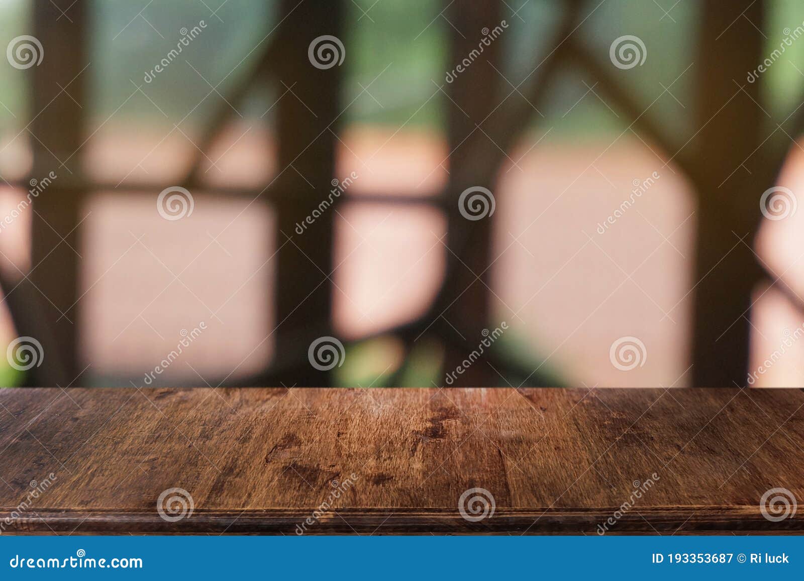 empty dark wooden table in front of abstract blurred bokeh background of restaurant.