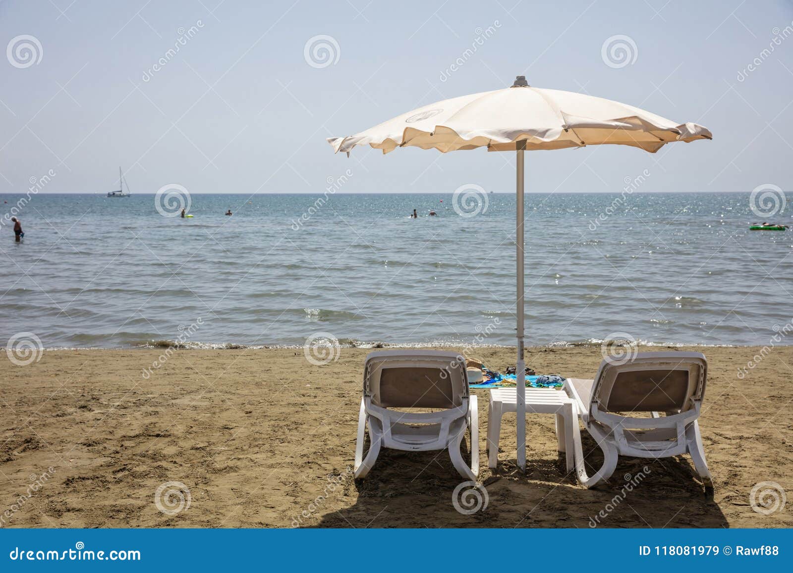 Deck Chairs And Umbrella On A Sandy Beach Sea Water