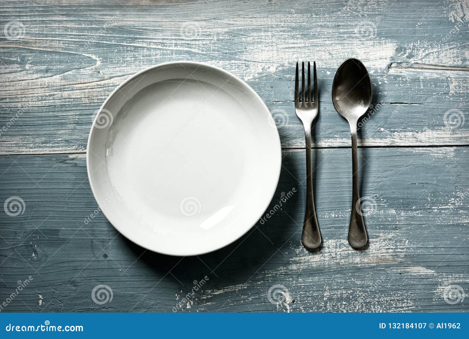 Empty Dish with Fork and Spoon on Blue Table Vintage Effect Stock