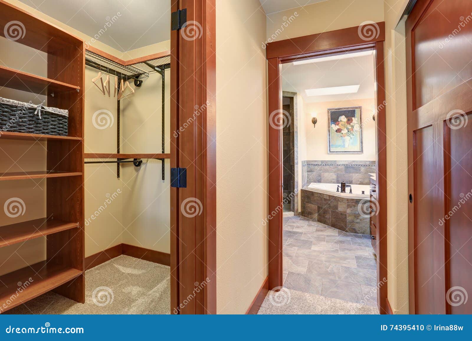 Empty Dressing Room with Carpet Floor and View of Master Bathroom