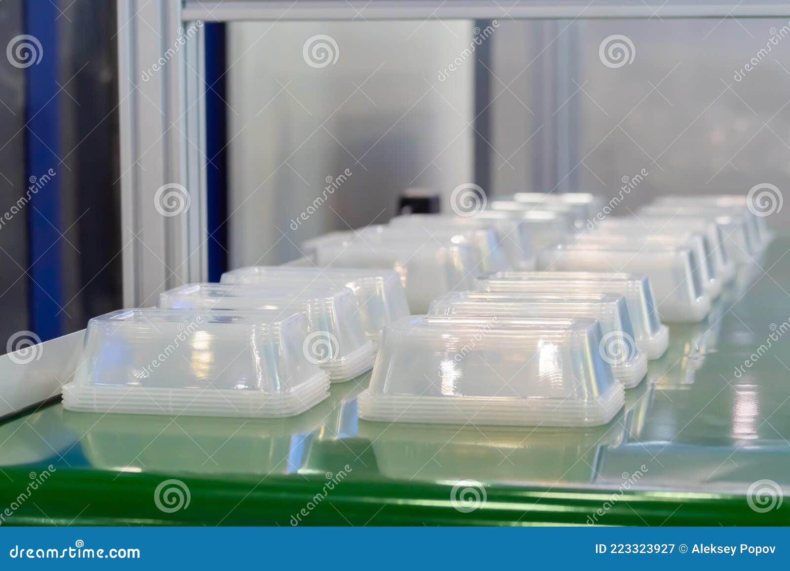 Empty Food Containers on Conveyor Belt of Plastic Injection Molding