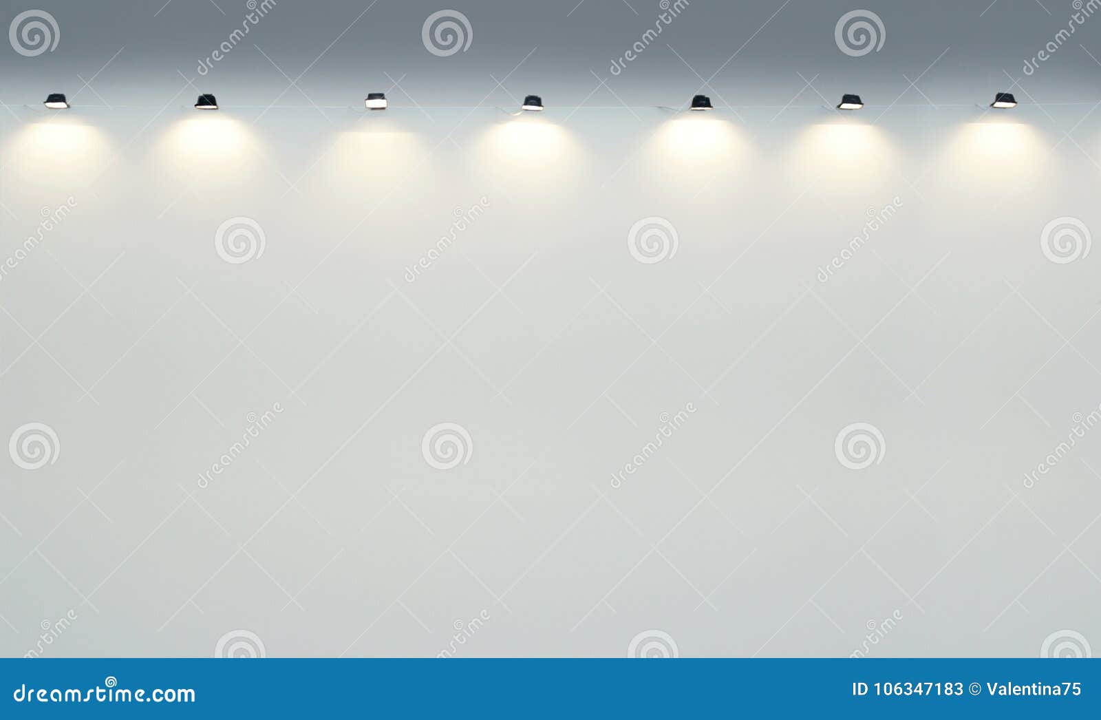 empty gallery wall with spotlights