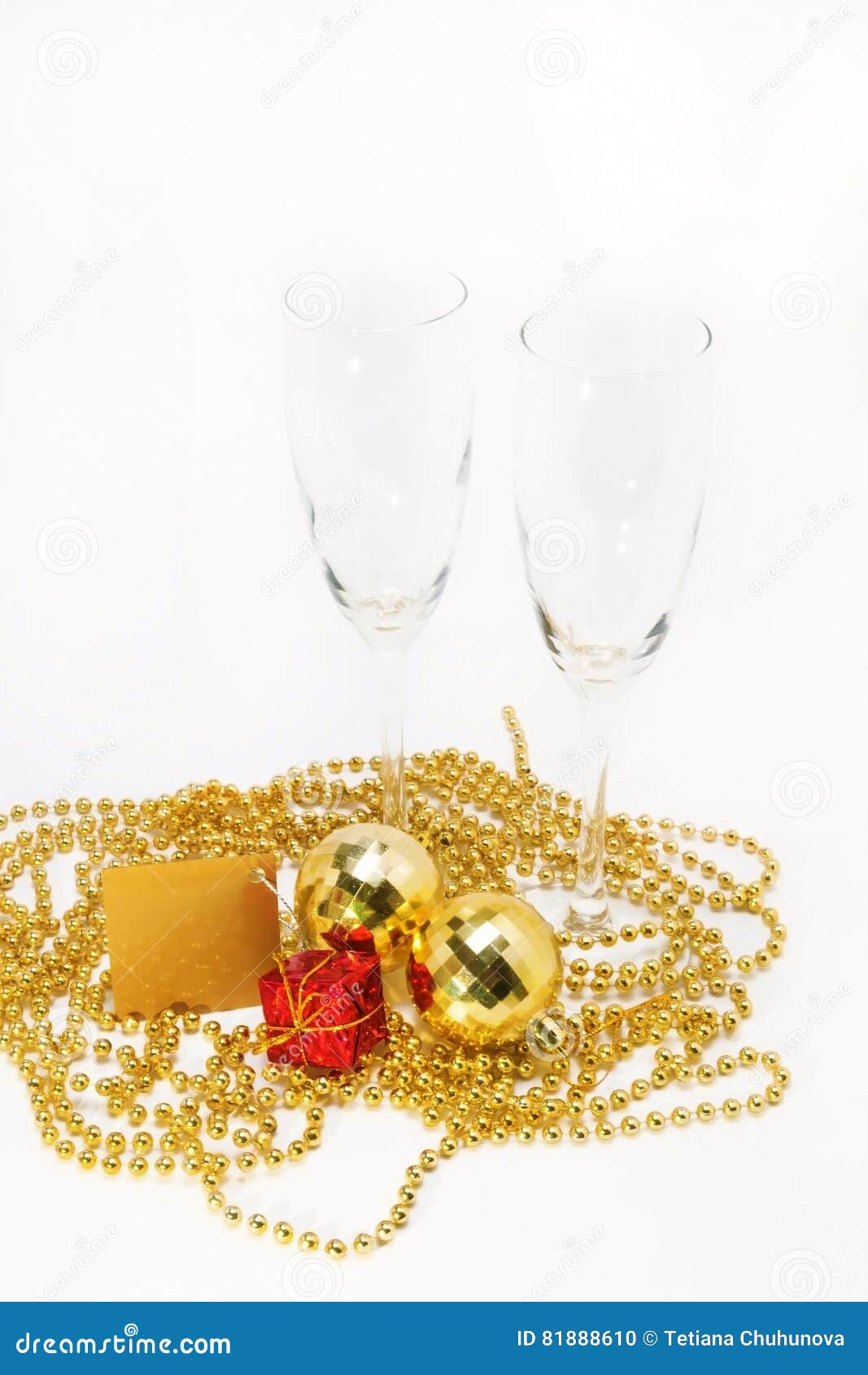 Empty Glasses and Gold Christmas Decorations Isolated Stock Photo