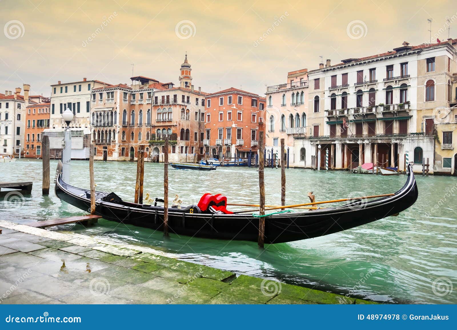 Empty gondola parked in Venice. A view of an empty gondola parked in a Campo Erberia square on grand canal in Venice, Italy.