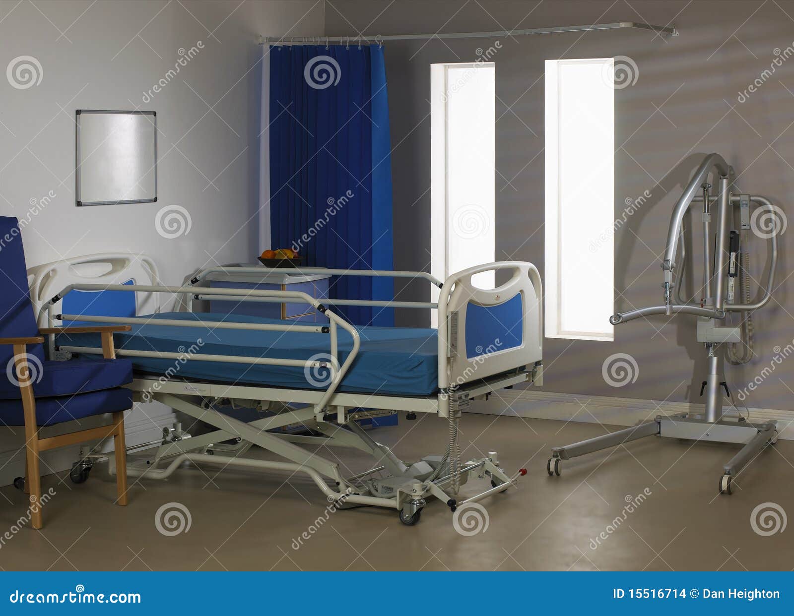empty hospital ward with bed chair and hoist