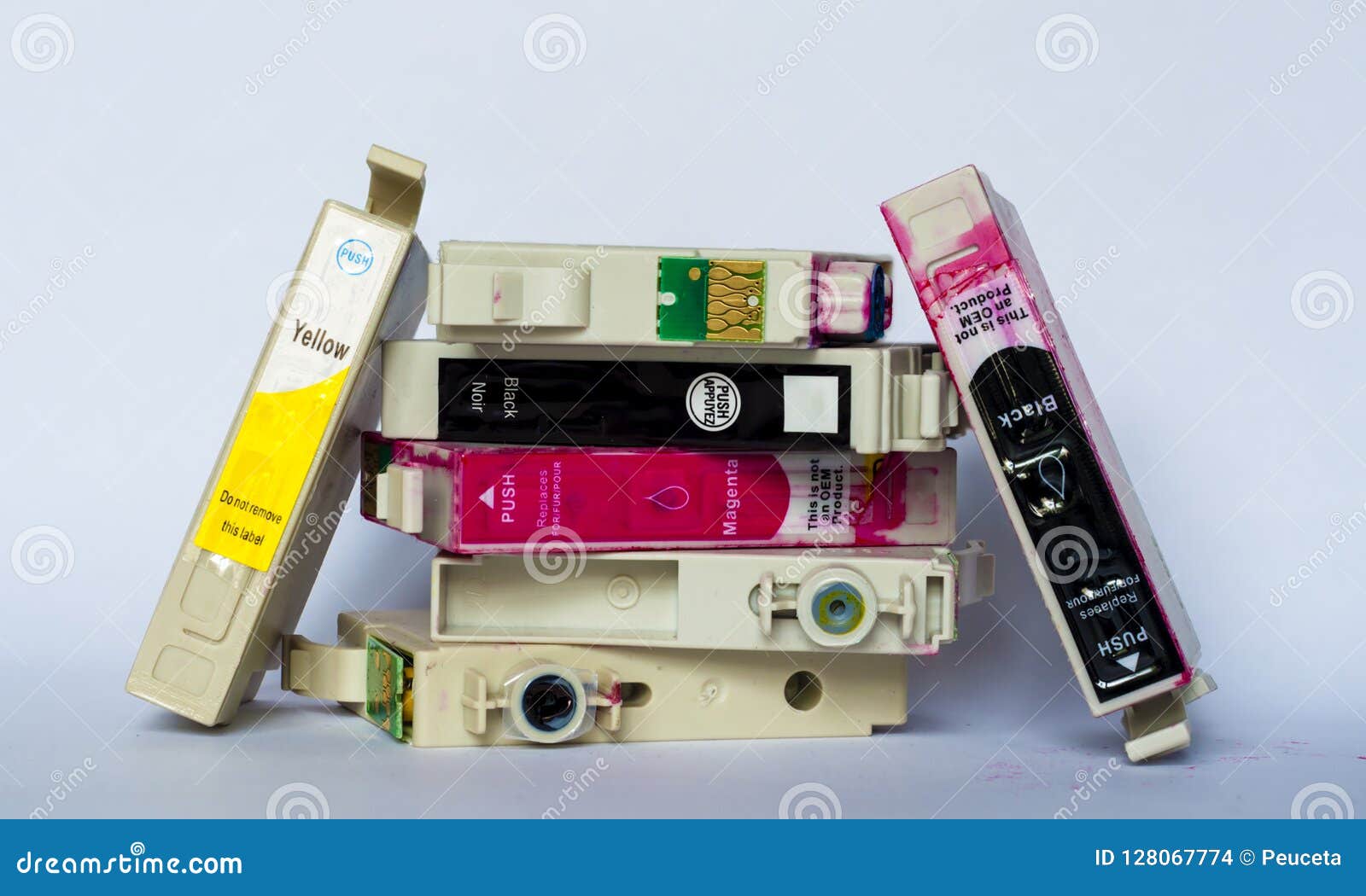 Empty Ink Cartridges with Labels of Various Colors Stacked on Wh Stock