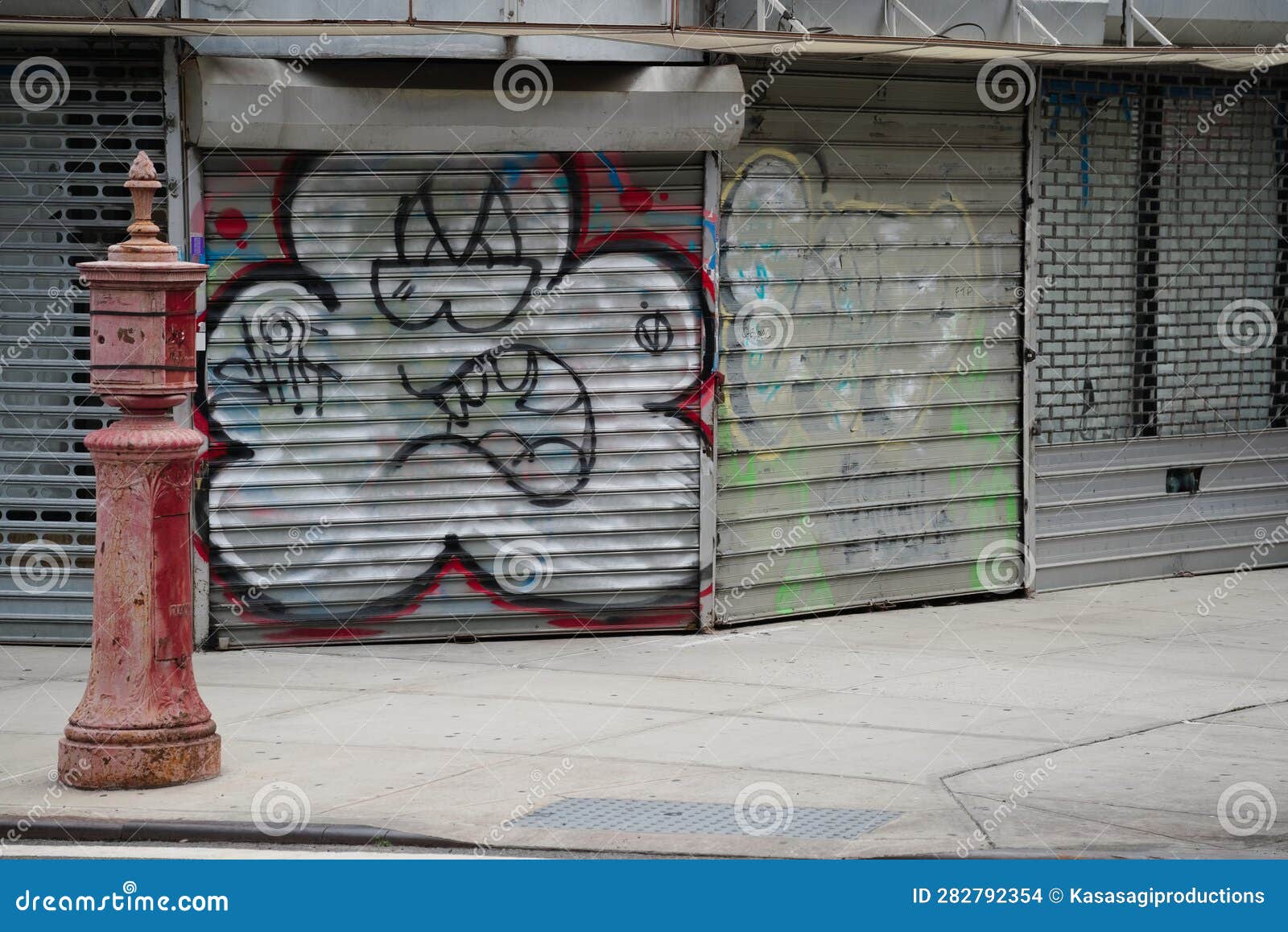 Empty Inner City Corner Store Closed with Metal Shutters and Graffiti