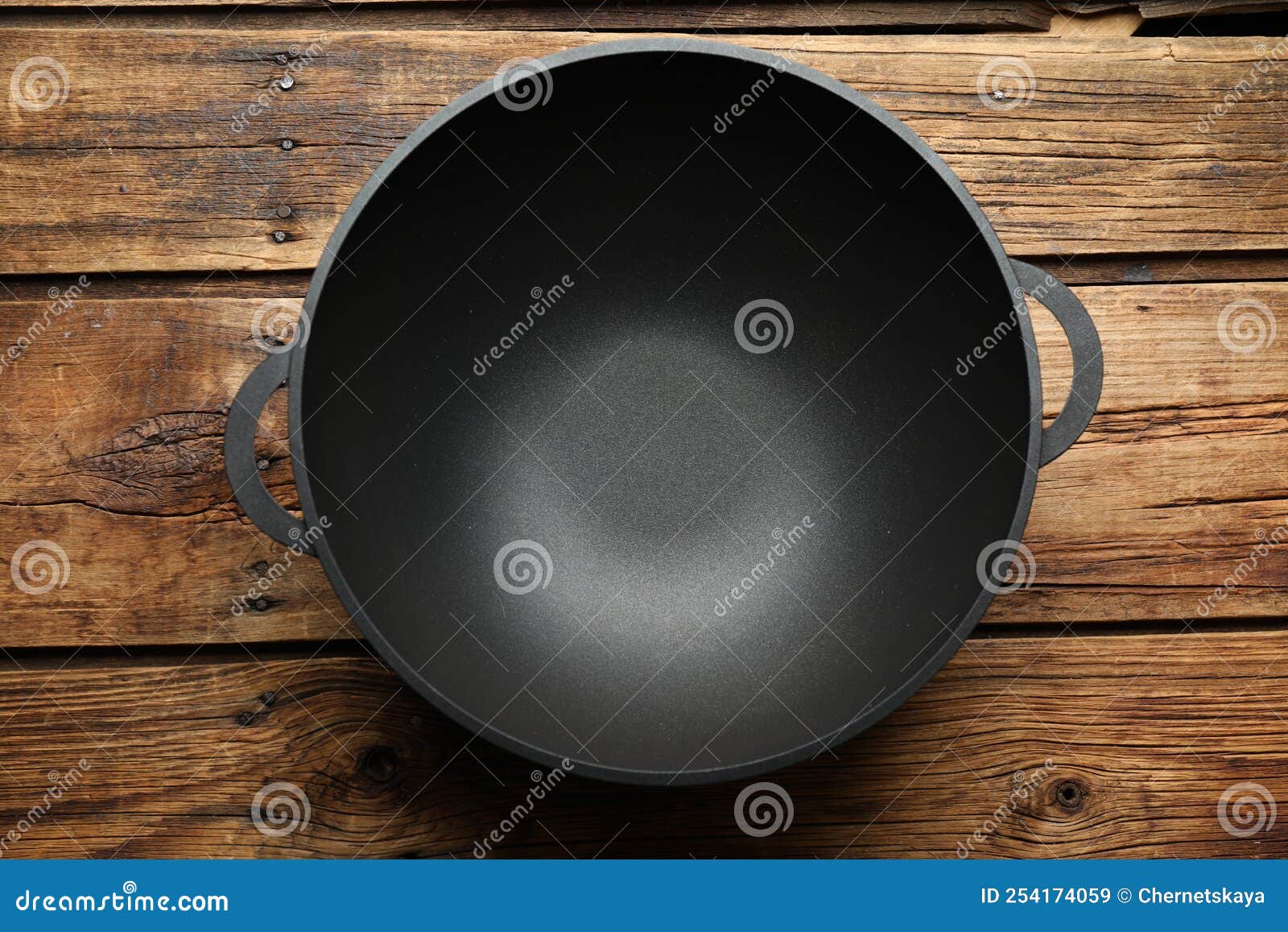 Empty Iron Wok on Wooden Table, Top View. Chinese Cookware Stock Image