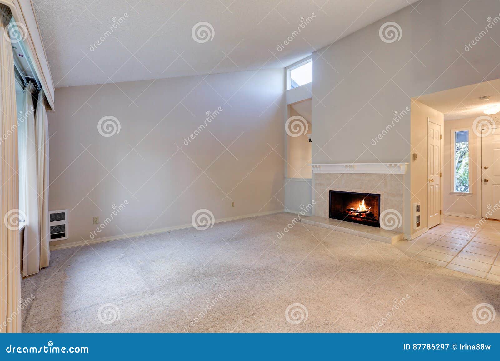 Empty Living Space With Vaulted Ceiling And Grey Walls Stock Image