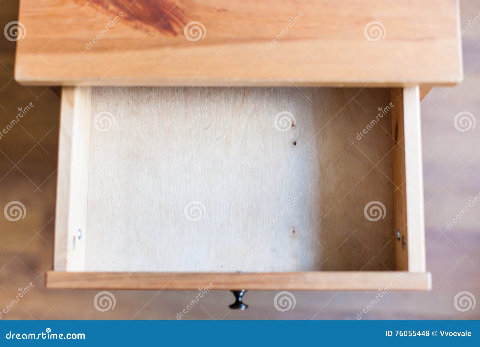 empty open drawer of wooden nightstand