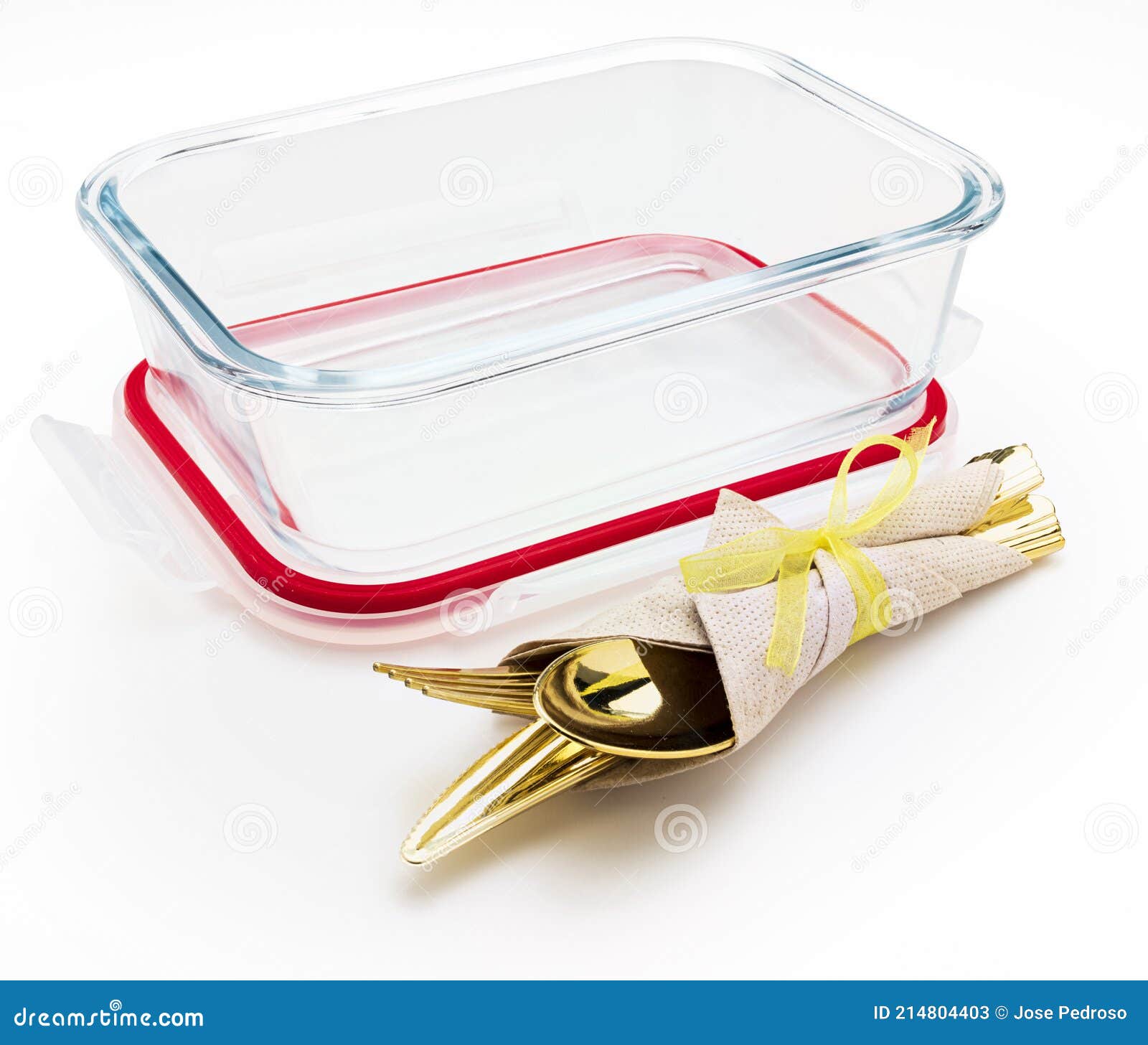 empty and open glass tupperware with cutlery and napkin.  on white background