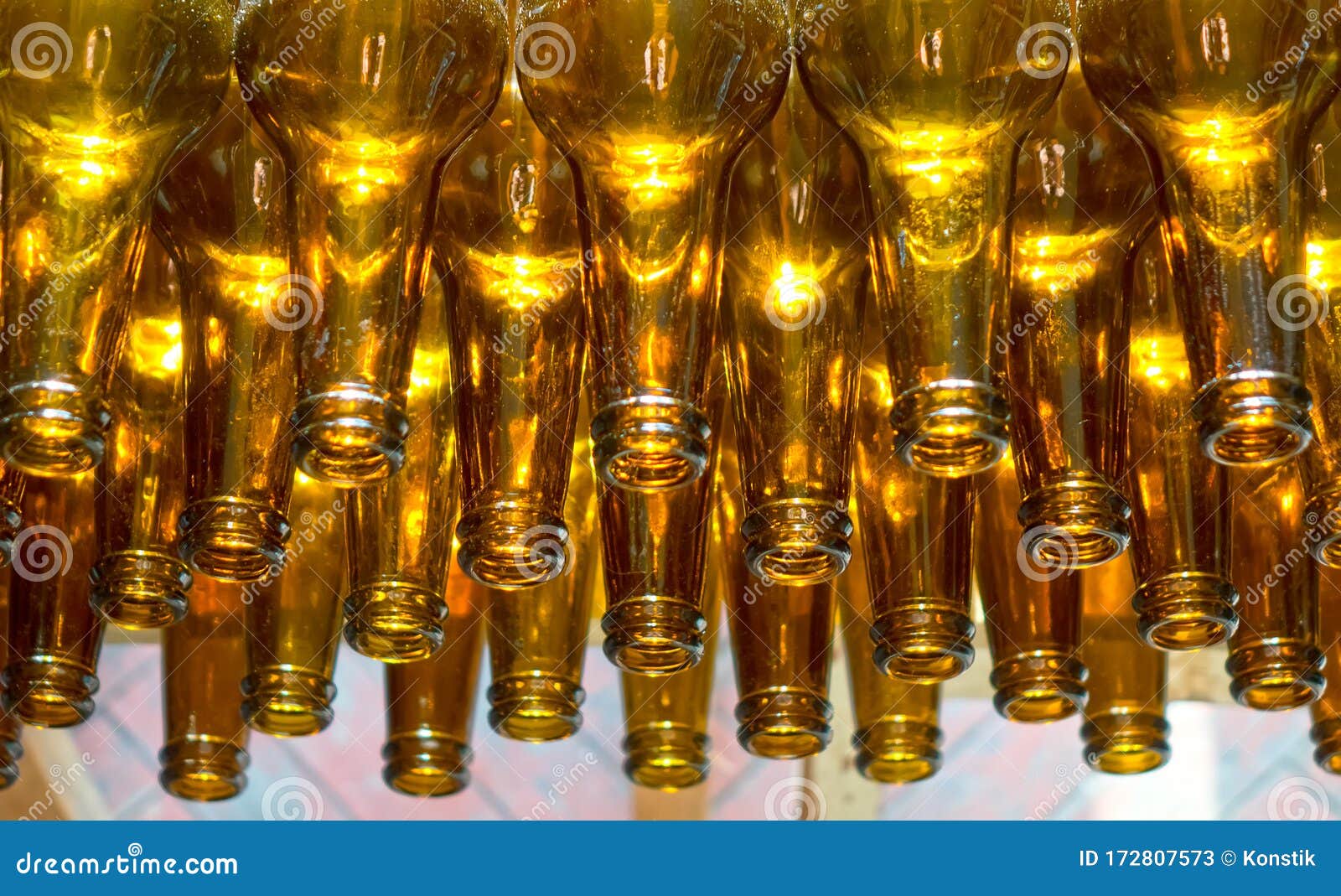 empty orange beer glass bottles necking down