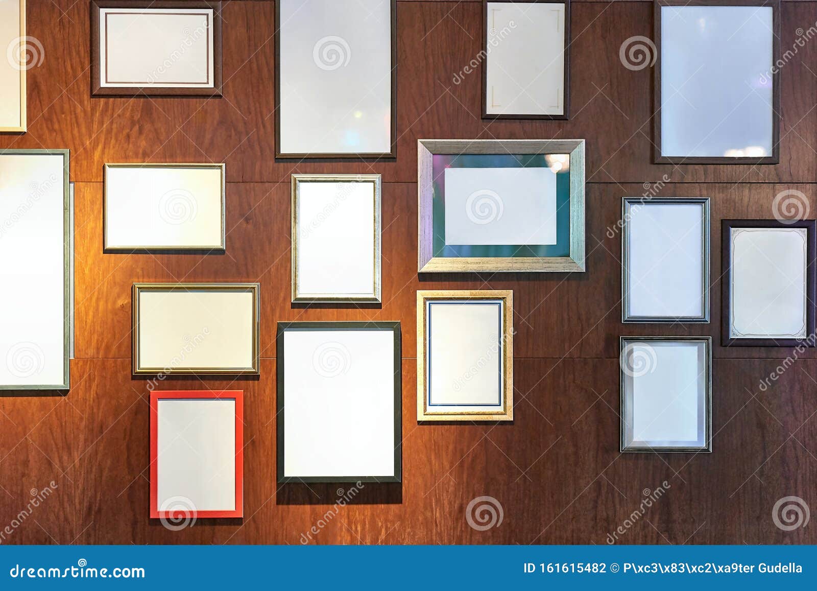 blank picture frames on a wall gallery