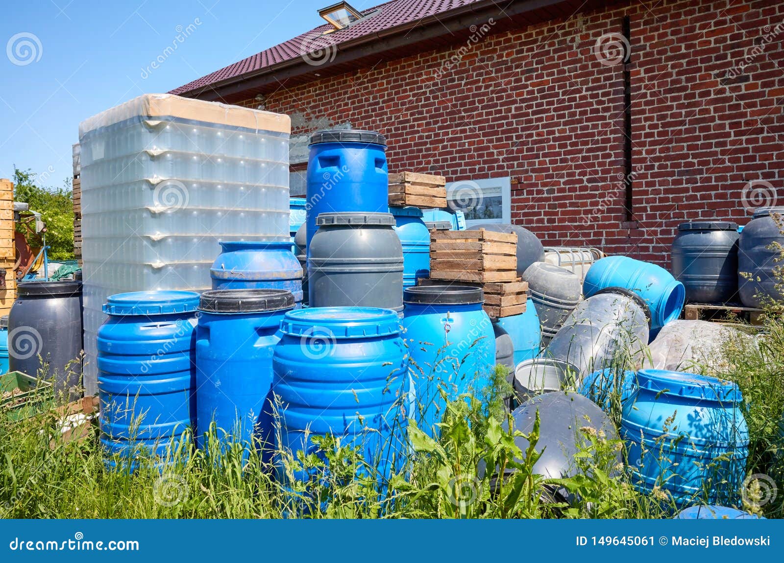 Empty Plastic Barrels and Containers Used in Food Processing Piled at a