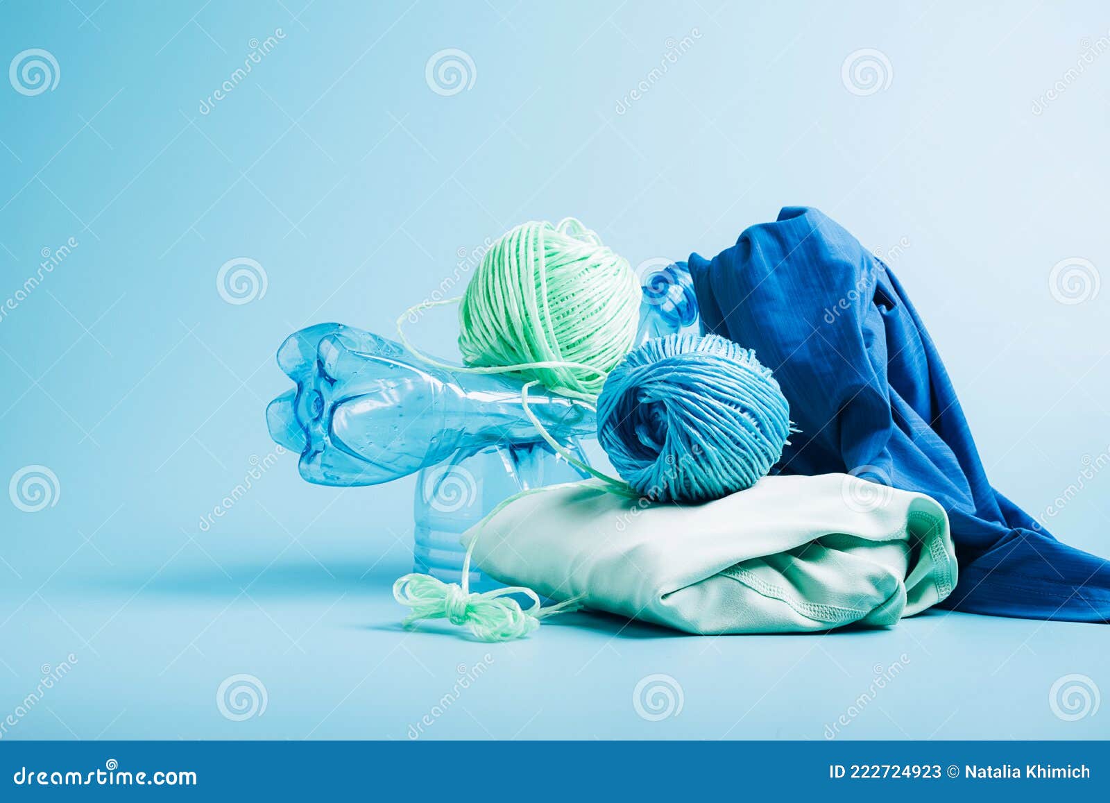 Empty Plastic Bottle and Various Fabrics Made of Recycled Polyester