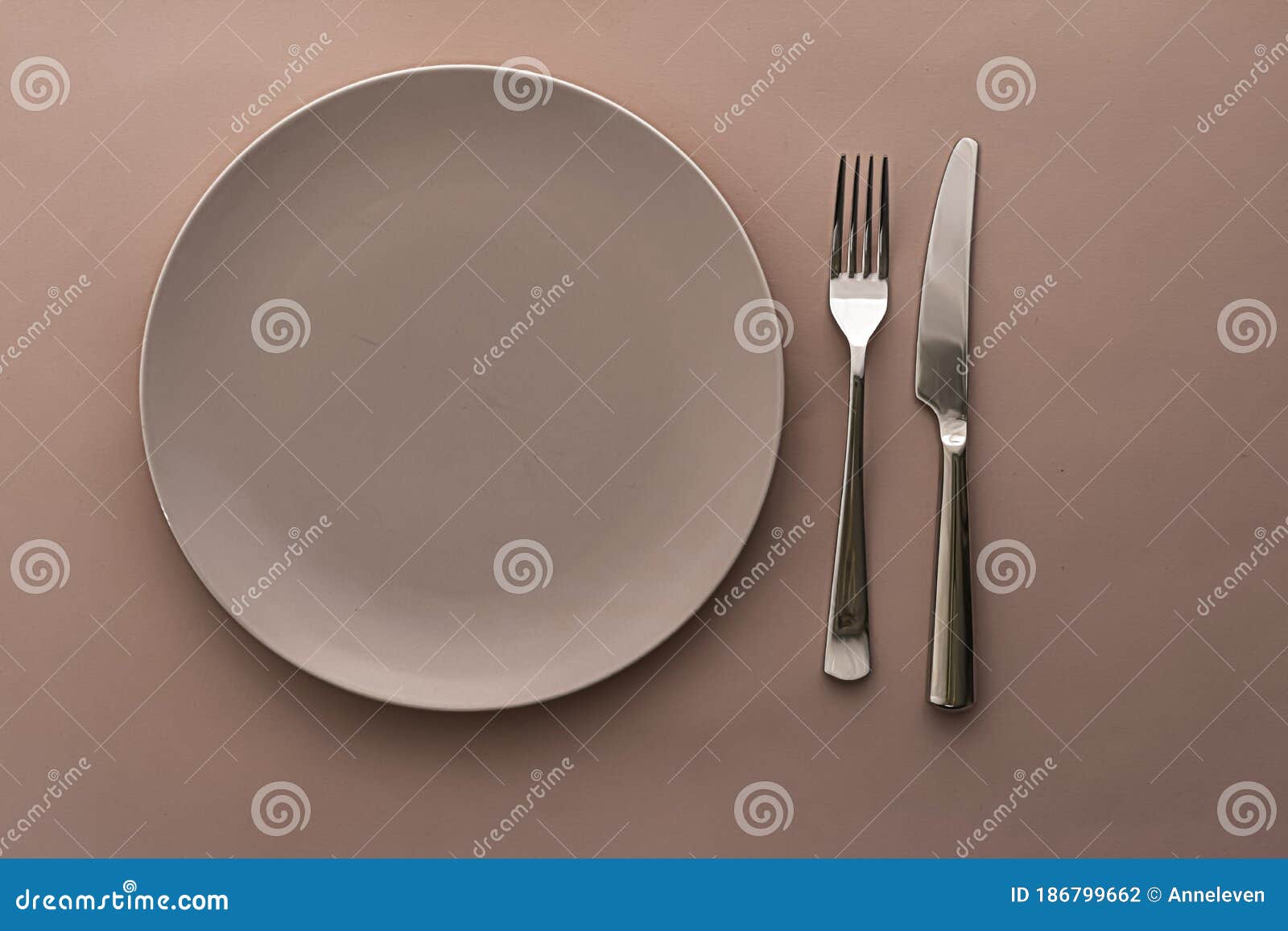 Download Empty Plate And Cutlery As Mockup Set On Brown Background ...