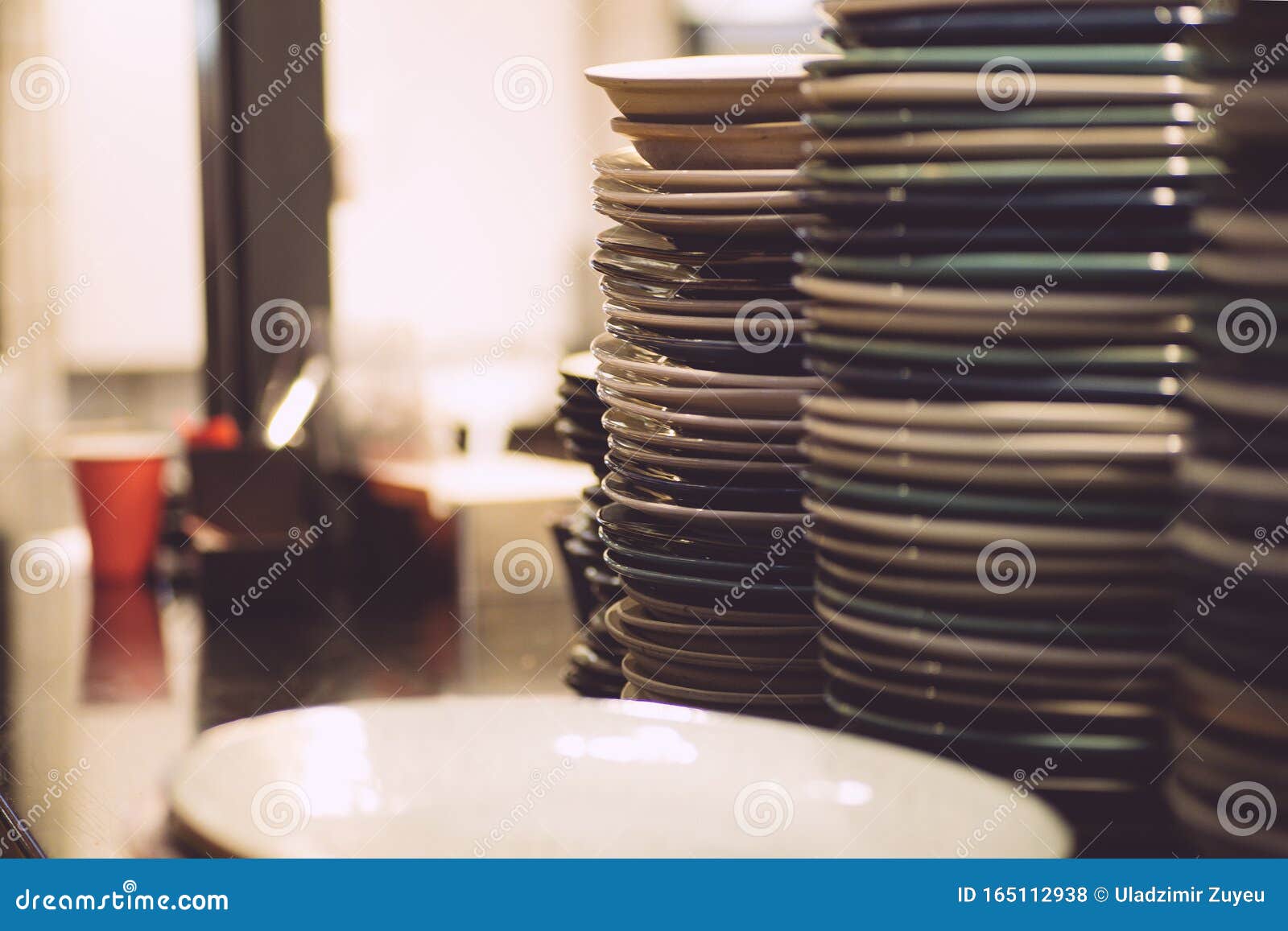 Empty Plates Dishes on a Kitchen Table in a Restaurant. Dishes for