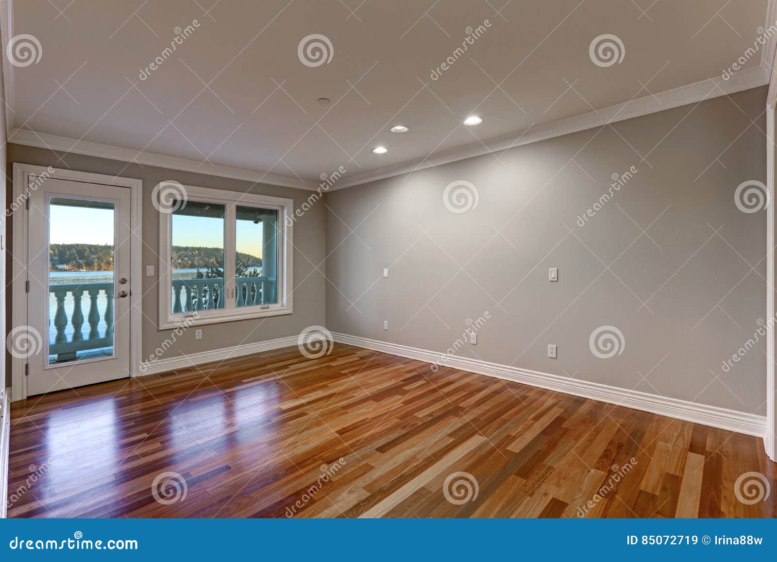 Empty Room With Hardwood Floor And Door To Balcony Stock Image