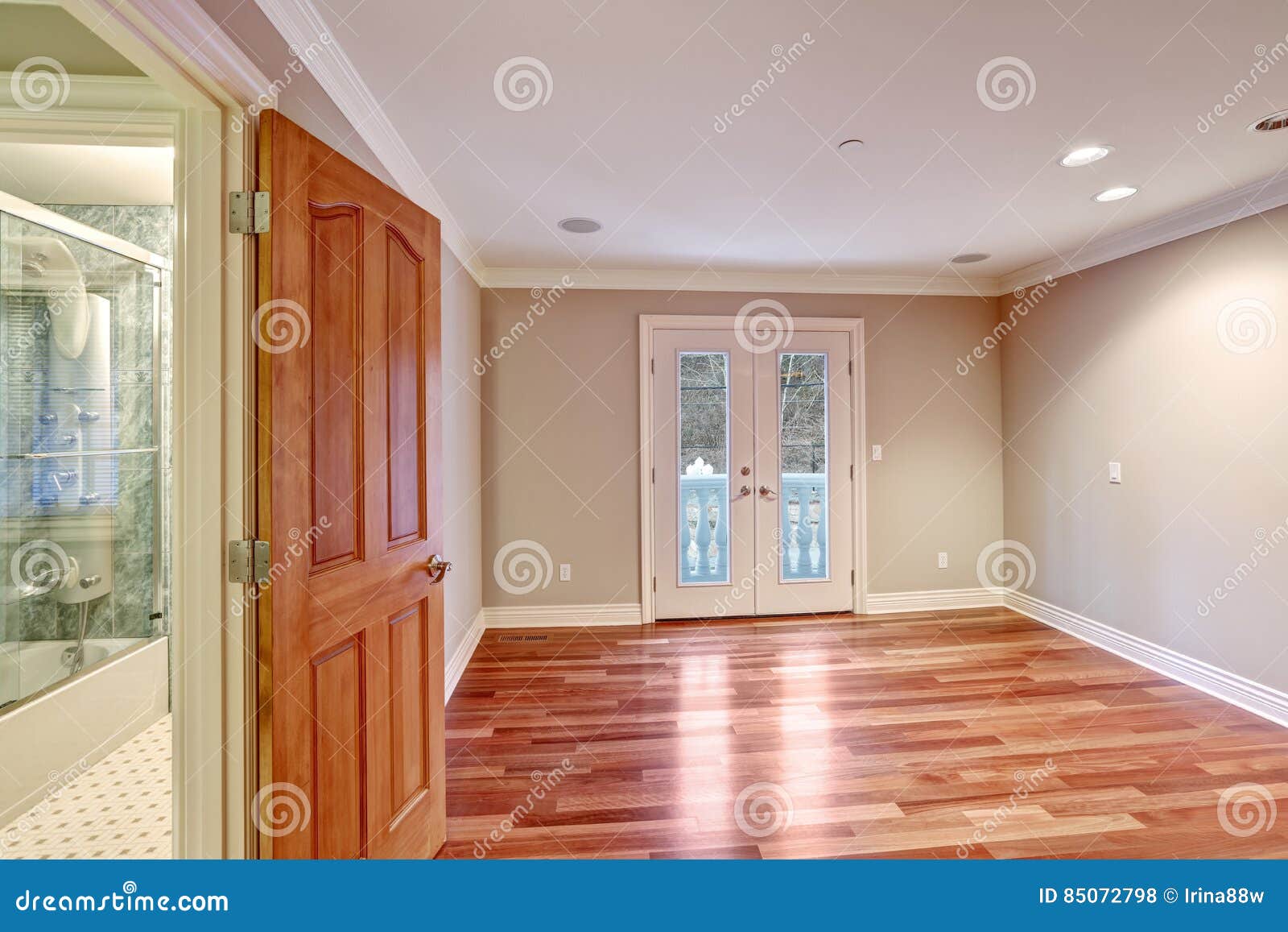 Empty Room With Hardwood Floor And Door To Balcony Stock Photo