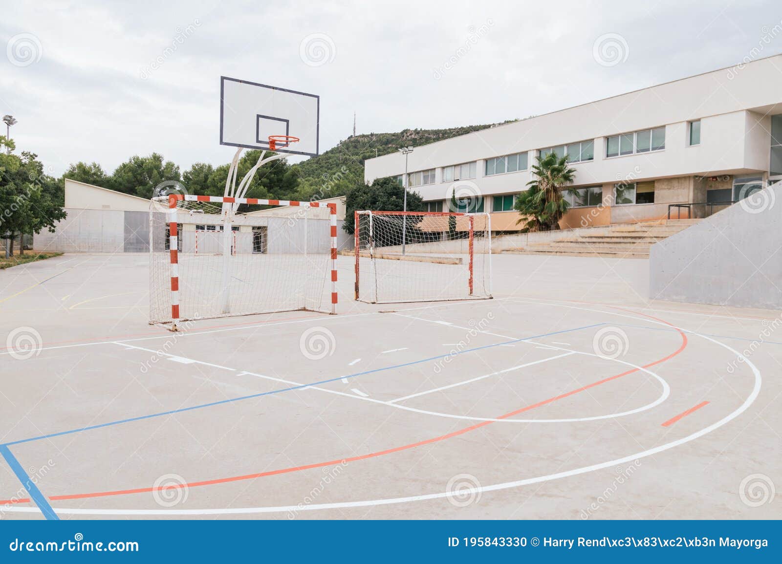 Soccer Goal and a Basketball Hoop in a School Playground Stock Photo