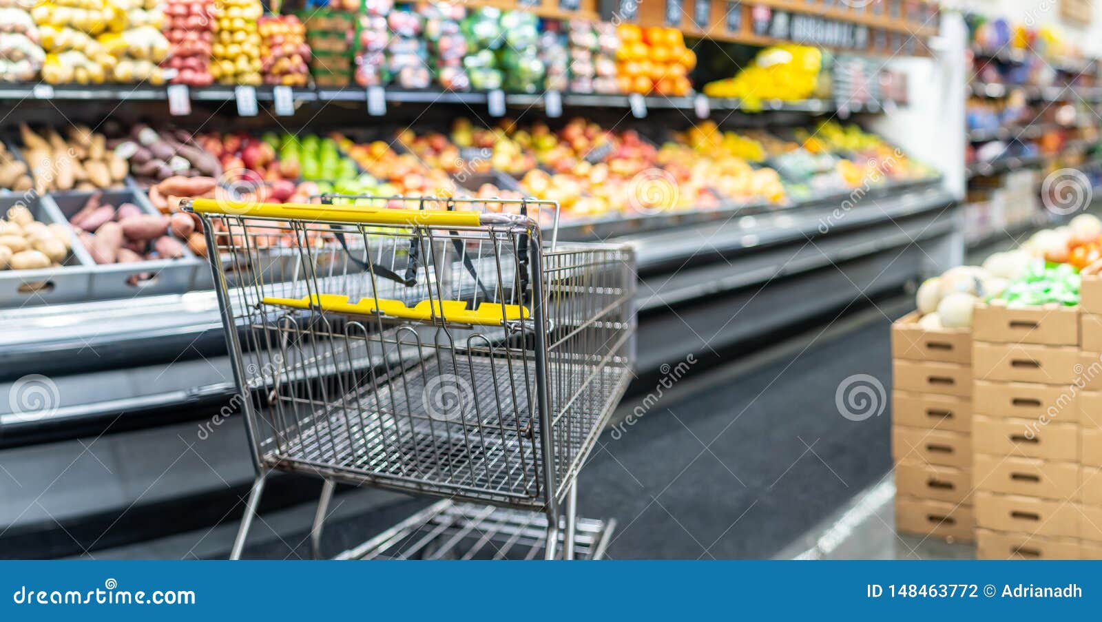 empty shopping cart at a supermarket produce and fruit  department