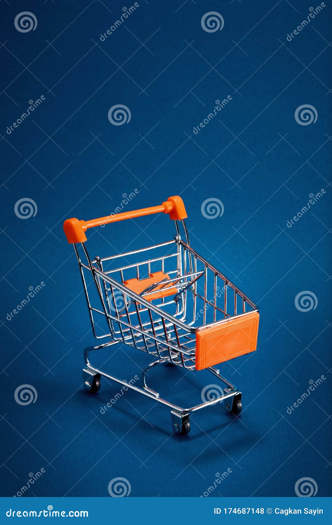 Empty Shopping Cart Trolley on Blue Background with Copy Space Stock