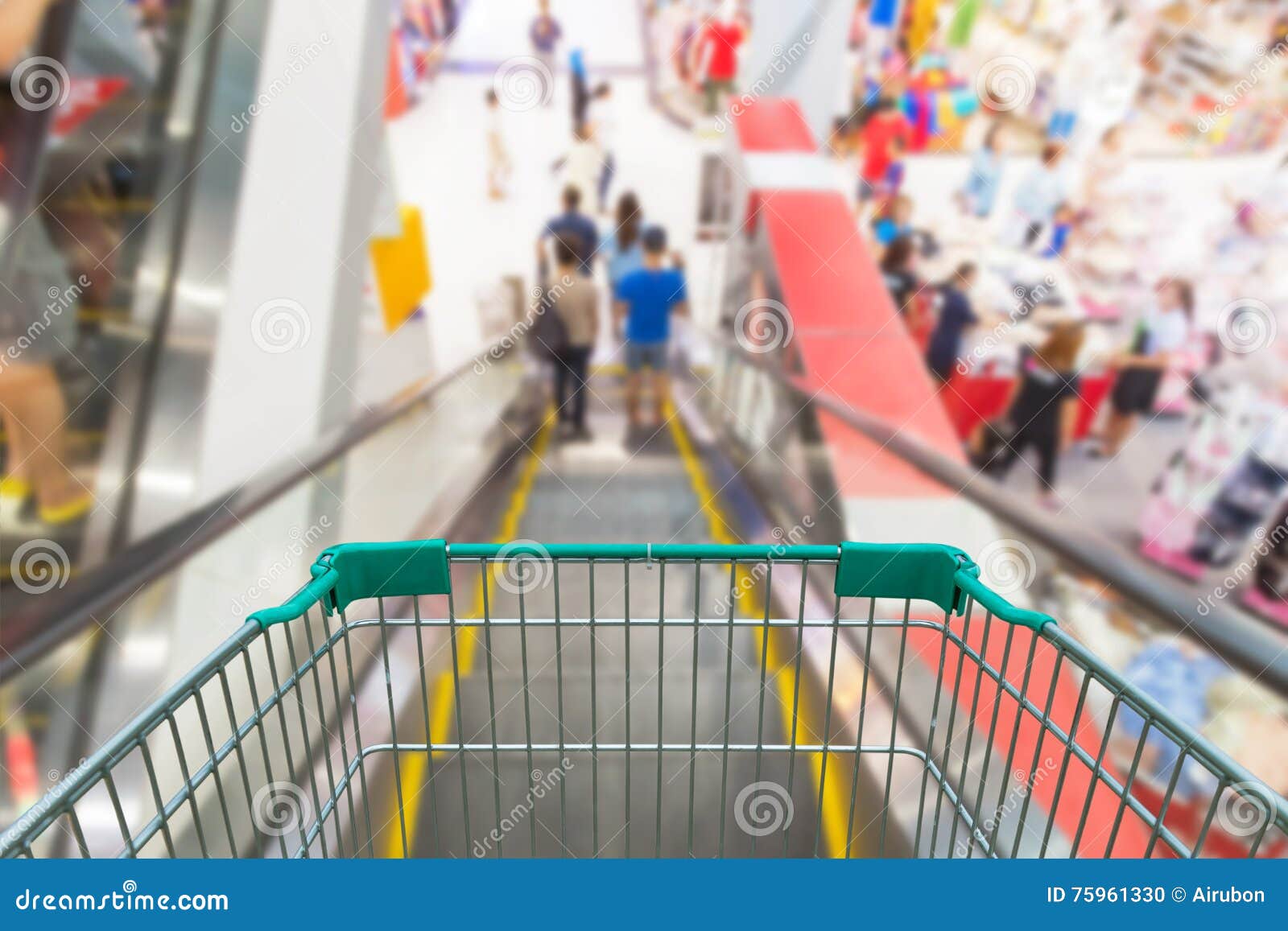Empty Shopping Trolley on Escalator in Shopping Mall. Stock Photo