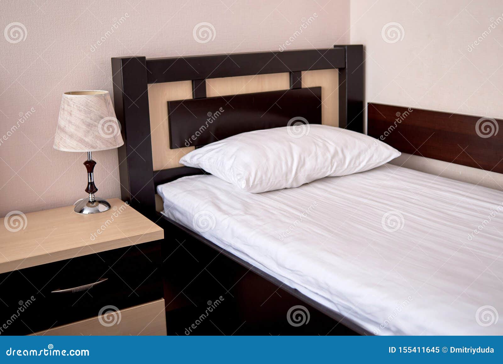 Empty Single Bed with Brown Wooden Headboard and White Soft Pillow ...