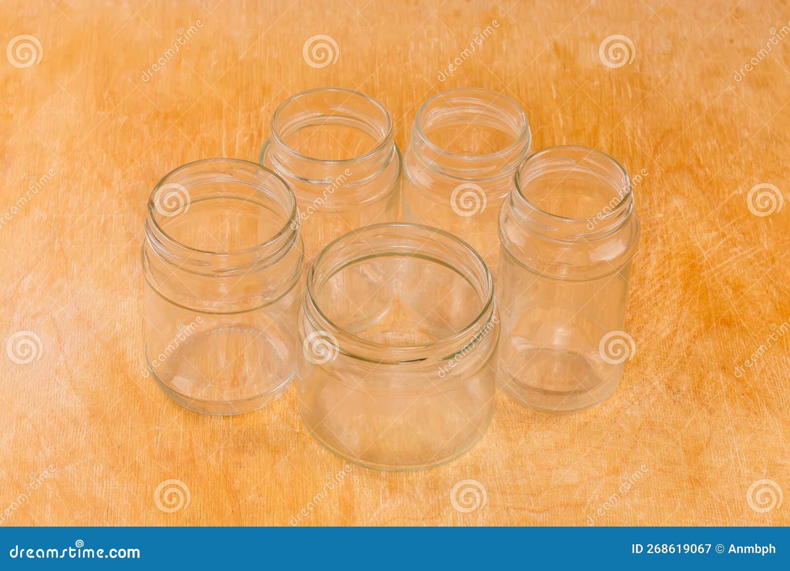 Empty Small Glass Jars Different Sizes on a Wooden Surface Stock Image