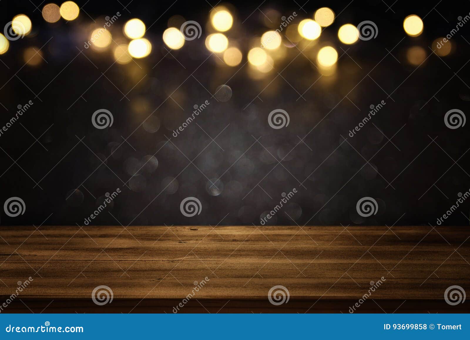 empty table in front of black and gold glitter lights background