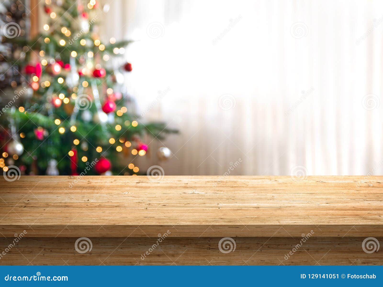 empty table top and christmas tree in background