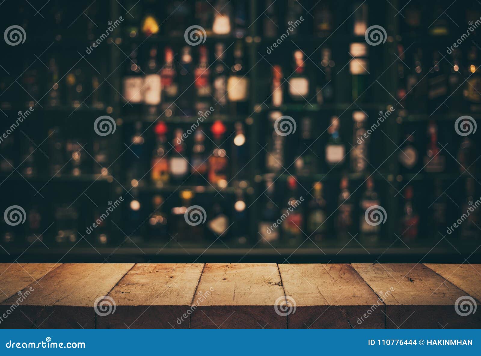 empty the top of wooden table with blurred counter bar and bottles