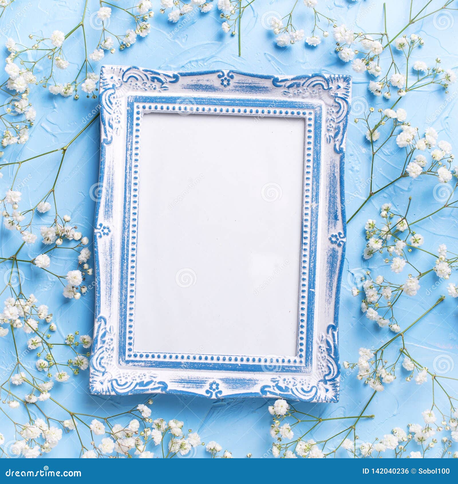 empty vintage frame and fresh white gypsofila flowers