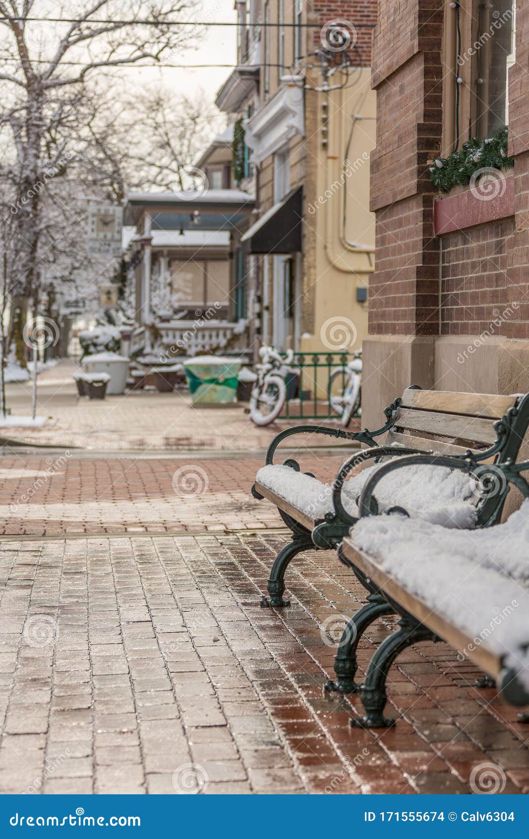 empty, wet, snowy, dreary winter street in small town