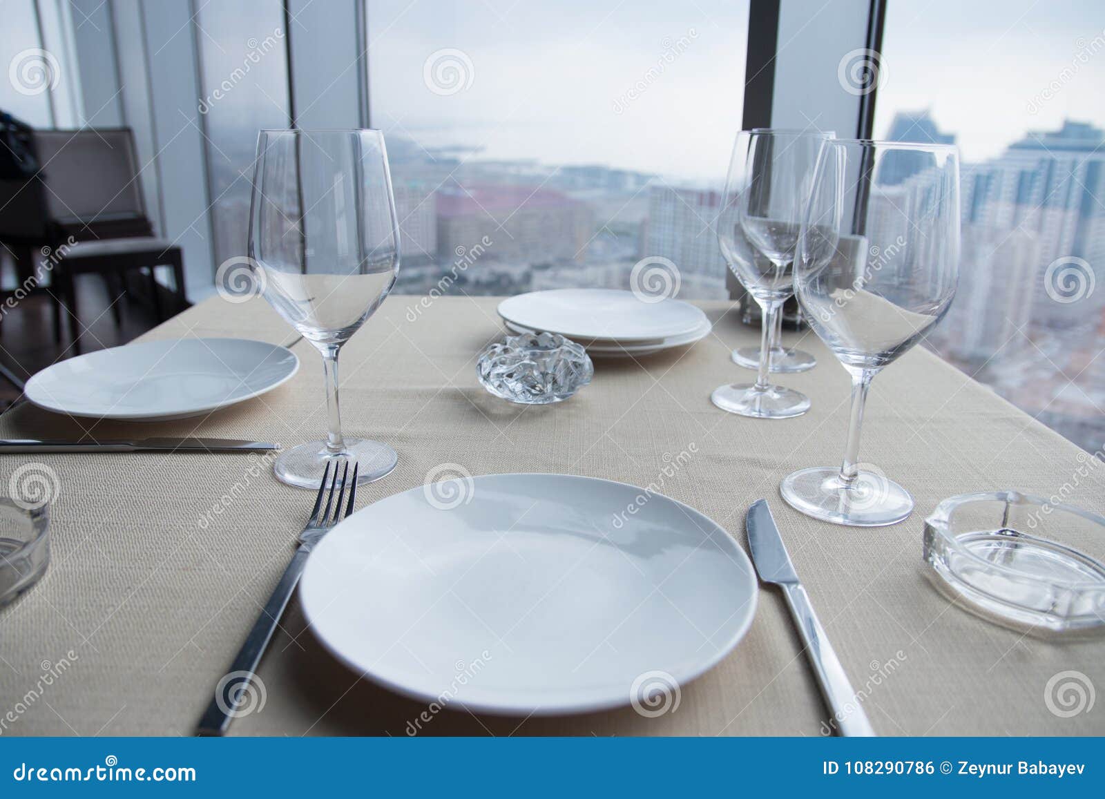 Empty White Plates on Table at a Restaurant with a Large Window View