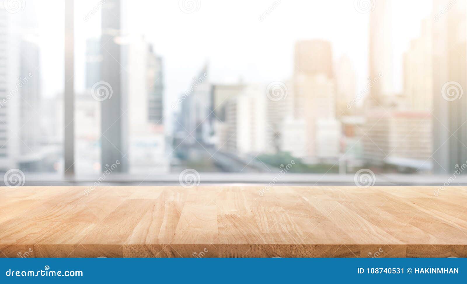 empty wood table with blur room office and window city view